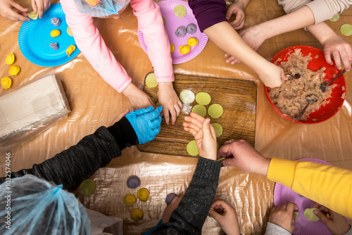 Wallpaper Mural Children aged 7-10 participating in a hands-on cooking class, learning to make ravioli or dumplings. The kids are excitedly shaping dough, enjoying a fun and educational culinary experience Torontodigital.ca