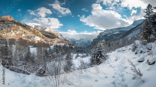 Panoramic view down snow covered valley in alpine mountain range