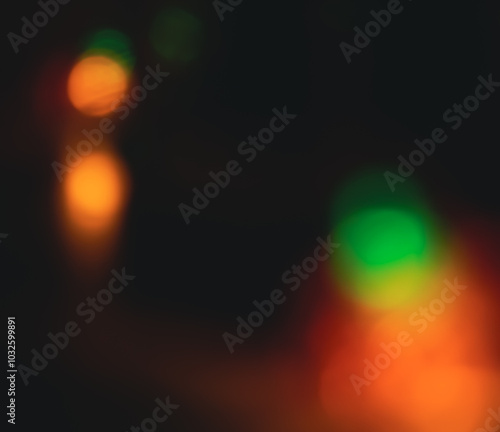 Dark background with multi-colored bokeh of different sizes