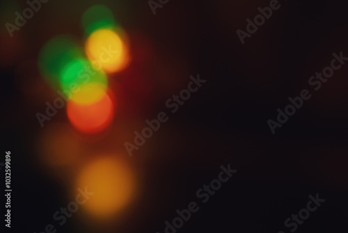 Dark background with multi-colored bokeh of different sizes
