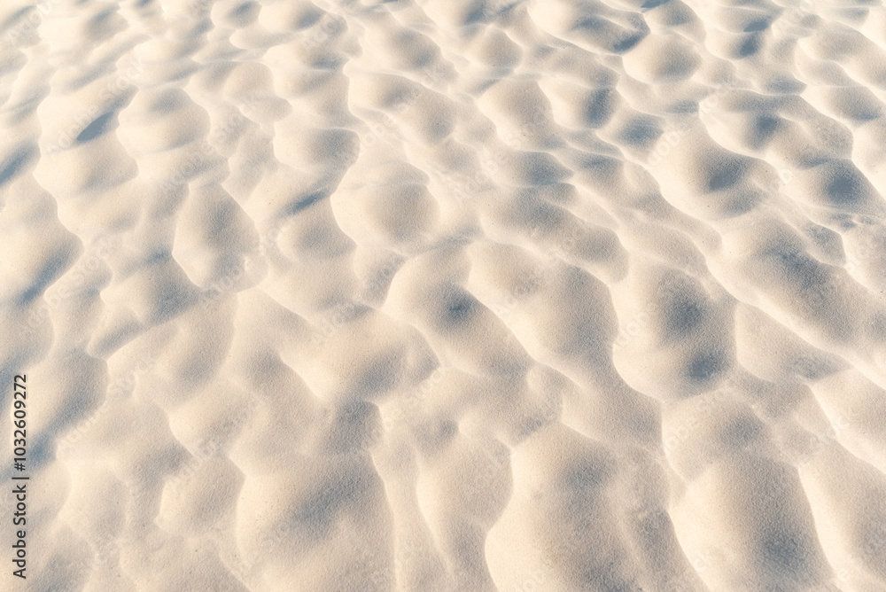 Close up of sand on beach. Clean sand with waves made by wind, beautiful nature texture Close up of sand on beach. Clean sand with waves made by wind, beautiful nature texture