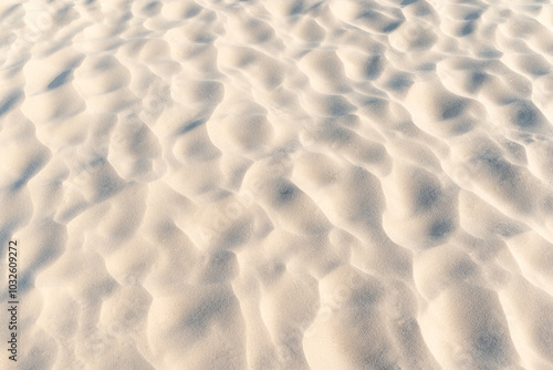 Close up of sand on beach. Clean sand with waves made by wind, beautiful nature texture