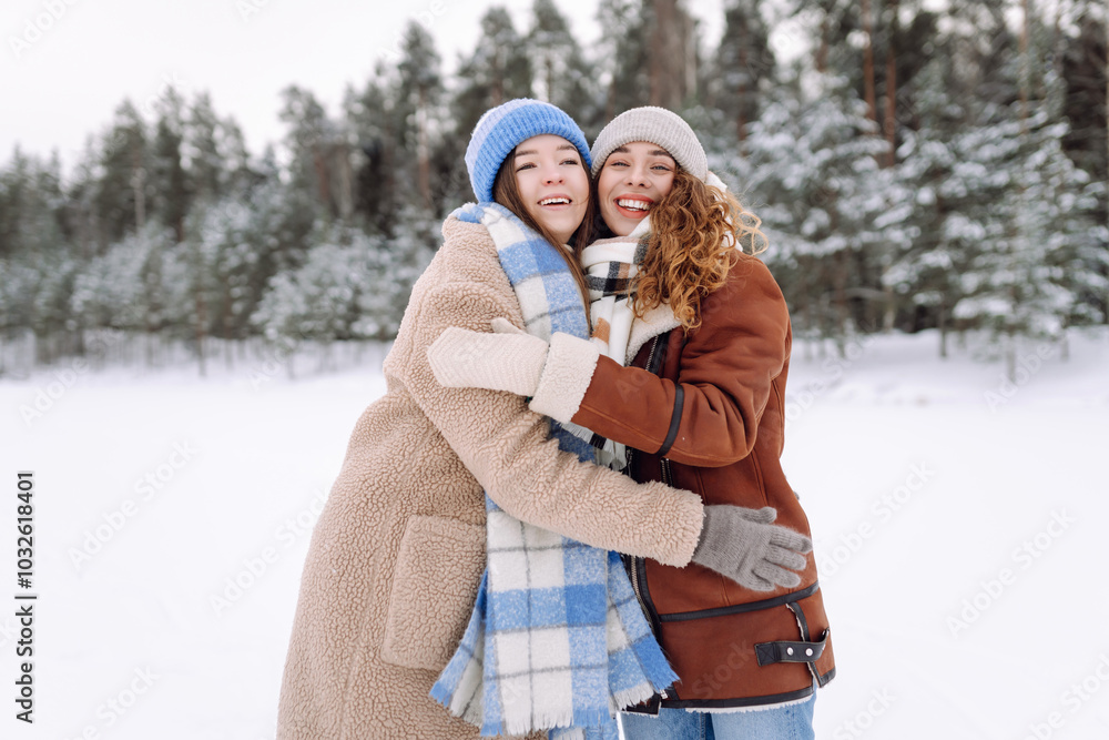 Fototapeta premium Happy friends having fun playing in winter park. Friends communicate and enjoying nature.