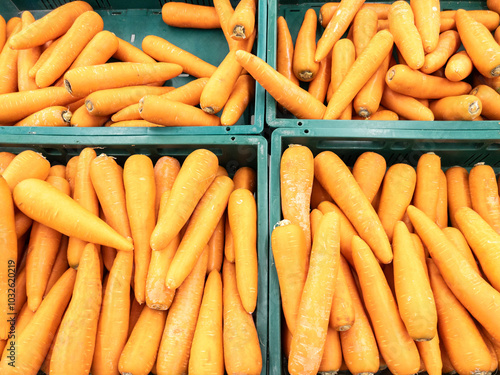 Closeup of the organic carrot in the plastic crate.