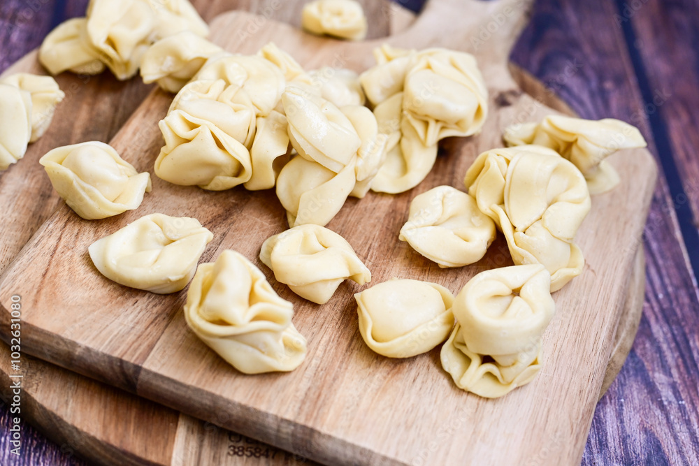 Raw fresh tortelloni pasta c Ring-shaped pasta filled with spinach and ricotta cheese. Ready for cooking. Italian food concept. Raw fresh tortelloni pasta c Ring-shaped pasta filled with spinach and ricotta cheese. Ready for cooking. Italian food concept.