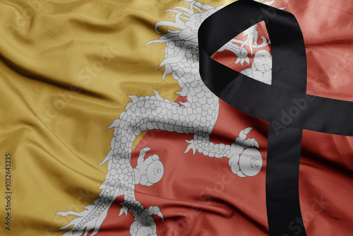 waving national flag of bhutan with black mourning ribbon .tragedy concept