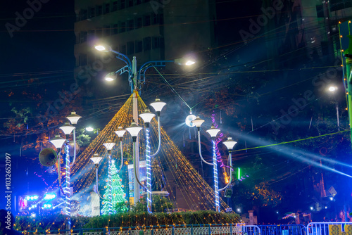 Decorated lights and Christmas celebration at illuminated Park street and Camac Street junction . Citizens enjoying with joy and year end festive mood photo