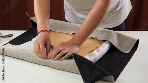 fixating upholstery fabric on chair seat with staple gun detail