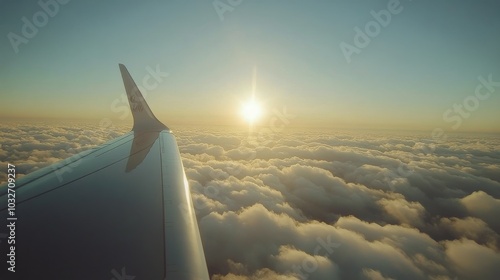 Aerial view of a plane wing above fluffy clouds at sunset during a scenic flight