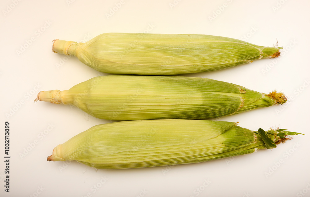 Three ears of corn on a white background. A printed cob. Ripe corn. Three ears of corn on a white background. A printed cob. Ripe corn.