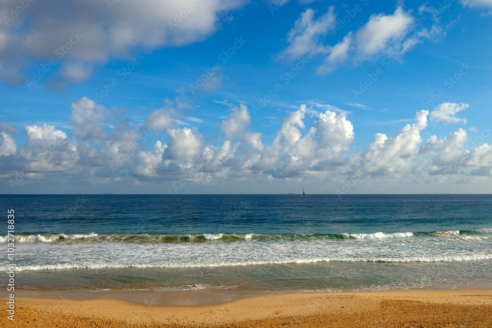 Clear sunny day at seaside. Yellow sand and blue ocean Clear sunny day at seaside. Yellow sand and blue ocean