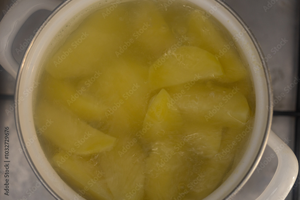 closeup of boiling potato in pan closeup of boiling potato in pan