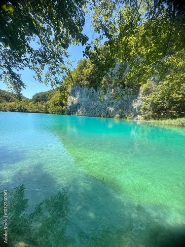 Plitvice Lakes in Croatia, a breathtaking natural wonder, transforms into a lush paradise during summer. Vibrant green forests, cascading waterfalls, and crystal-clear lakes create a serene, enchantin