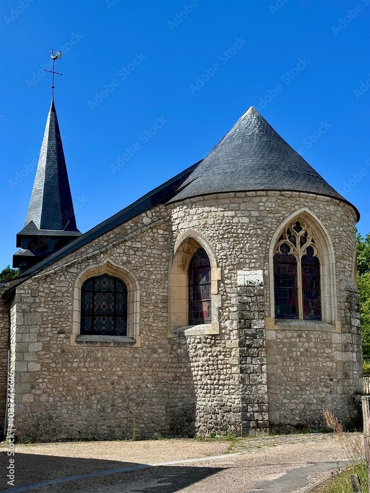 Fototapeta premium view of a small church of a small village in the French countryside on a summer day 