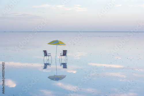 Umbrella and reflection in the unique waters of the Salt Lake coast. photo