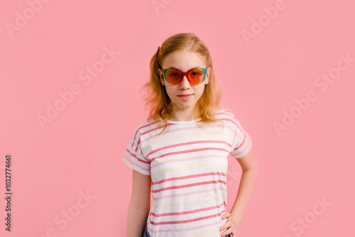 Emotional blonde teen girl in sparkle sunglasses laughing to camera on pink background