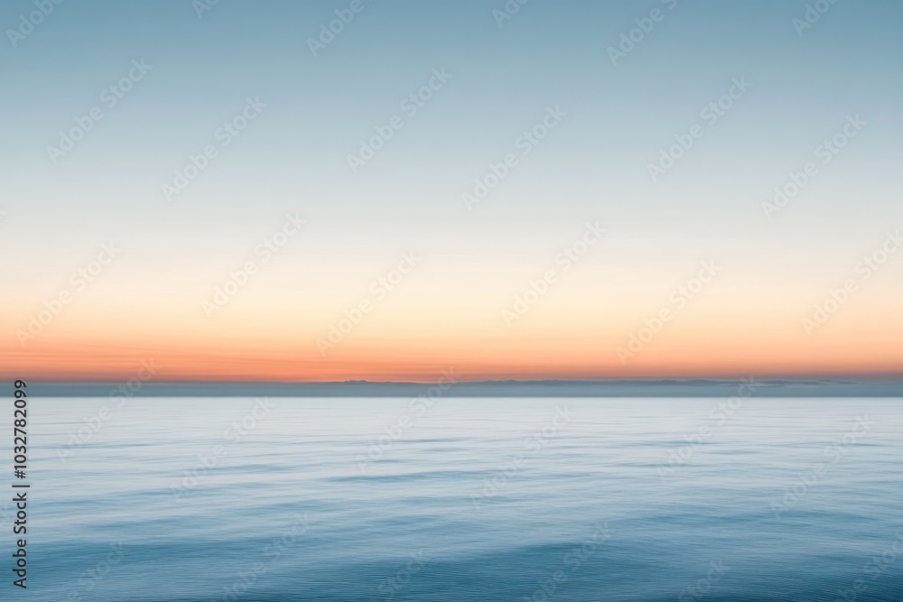 Obraz premium Calm Ocean Surface with a Pink-Orange Sunset Horizon
