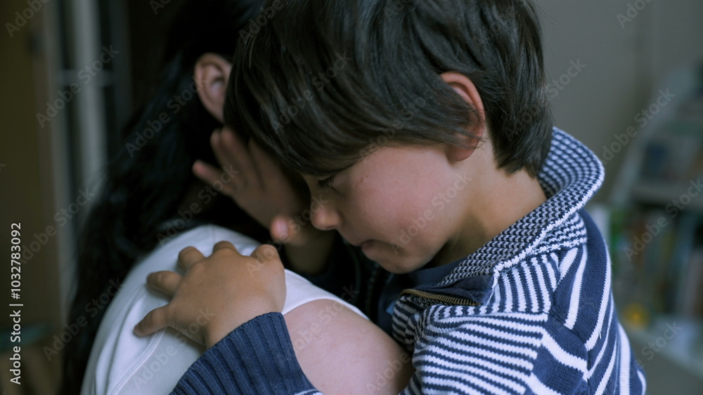 Young boy feeling sad while being comforted by his mother. child rests on her shoulder, showing visible distress and seeking comfort in a calm home Young boy feeling sad while being comforted by his mother. child rests on her shoulder, showing visible distress and seeking comfort in a calm home