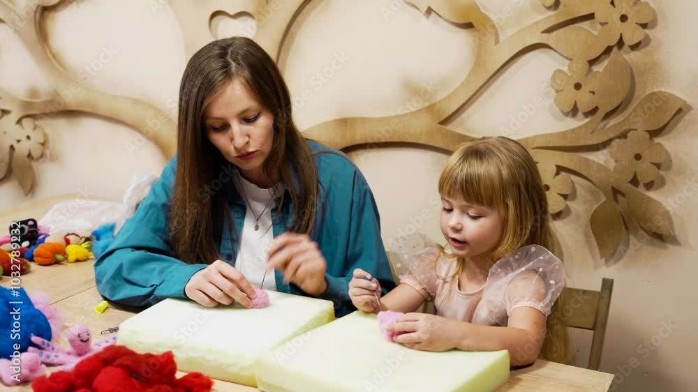 Crafting soft toys with a child at a creative workshop in autumn