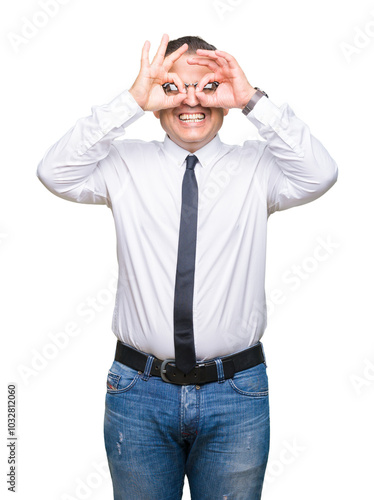 Middle age bussines arab man wearing glasses over isolated background doing ok gesture like binoculars sticking tongue out, eyes looking through fingers. Crazy expression.