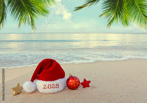 New Year 2025 background with red Santa hat on Caribbean beach.