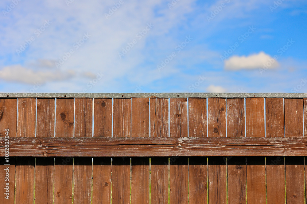 A Rustic Wooden Fence Set Against A Vibrant Blue Sky With Fluffy Clouds, Highlighting A Serene And Peaceful Outdoor Setting In Nature... A Rustic Wooden Fence Set Against A Vibrant Blue Sky With Fluffy Clouds, Highlighting A Serene And Peaceful Outdoor Setting In Nature...