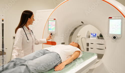 A doctor in a white coat operates an MRI machine, preparing a patient lying on the scanner bed for a diagnostic procedure in a modern medical facility focused on advanced healthcare technology.