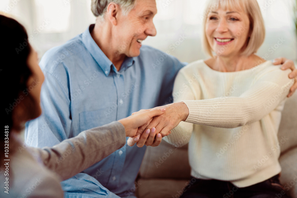 Gratitude For Help. Happy elderly couple giving handshake to female psychologist after successful session Gratitude For Help. Happy elderly couple giving handshake to female psychologist after successful session
