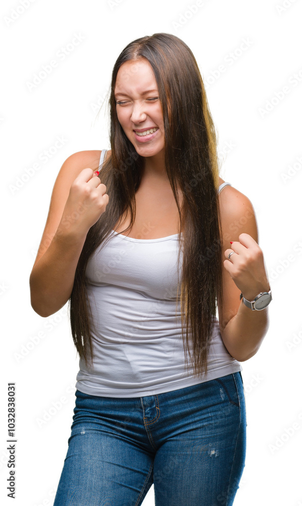 Fototapeta premium Young caucasian beautiful woman over isolated background very happy and excited doing winner gesture with arms raised, smiling and screaming for success. Celebration concept.