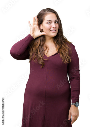 Beautiful and attractive plus size young woman wearing a dress over isolated background smiling with hand over ear listening an hearing to rumor or gossip. Deafness concept.