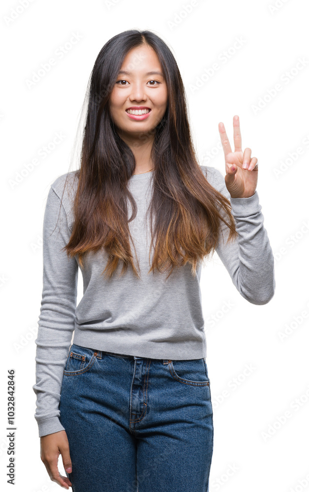 Young asian woman over isolated background smiling with happy face winking at the camera doing victory sign. Number two. Young asian woman over isolated background smiling with happy face winking at the camera doing victory sign. Number two.