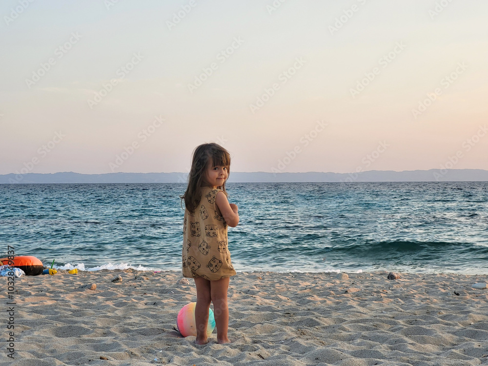 A little girl is enjoying her vacation in Greece on the beach A little girl is enjoying her vacation in Greece on the beach