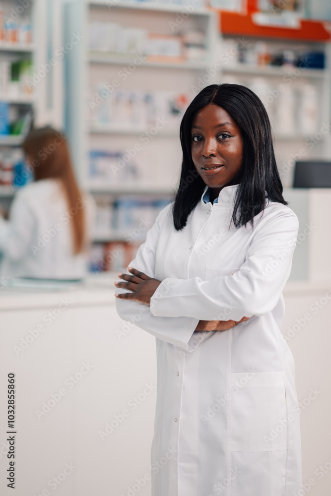 Confident black pharmacist posing with crossed arms in pharmacy Confident black pharmacist posing with crossed arms in pharmacy