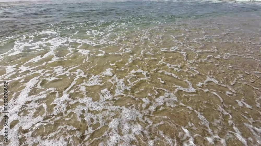 water of the waves on the shore of a beach on a day with the most calm, concept of summer background water of the waves on the shore of a beach on a day with the most calm, concept of summer background