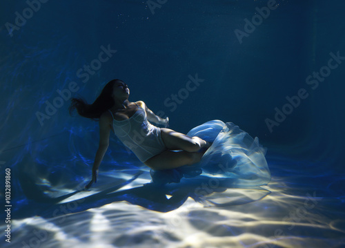 Wallpaper Mural Young woman in bikini sitting on a floor of a swimming pool underwater Torontodigital.ca