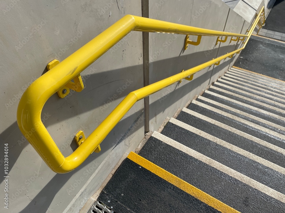 Yellow handrails, concealed lighting and non-slip stairs on new staircase at railway station Yellow handrails, concealed lighting and non-slip stairs on new staircase at railway station