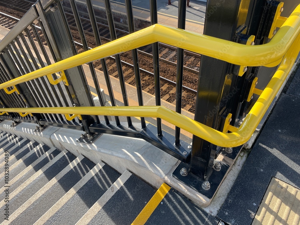 Yellow handrails and non-slip stairs on new staircase at railway station