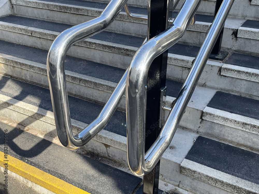 Chrome steel handrails and non-slip stairs on new staircase at railway station Chrome steel handrails and non-slip stairs on new staircase at railway station