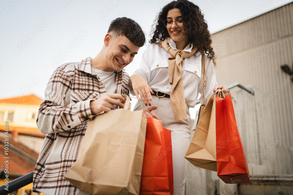 couple stand on stairs and hold shopping bags enjoy after shopping couple stand on stairs and hold shopping bags enjoy after shopping