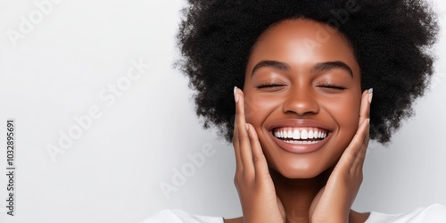 Happy young South American woman model applying facial moisturising serum enjoying a healthy glowing face and perfect skincare 