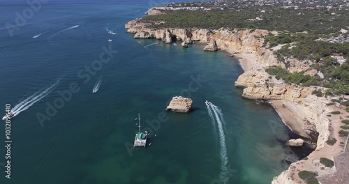 Wallpaper Mural Aerial drone view of Benagil sea caves and Atlantic Ocean coastline in Benagil, Algarve, Portugal, Europe. Boats sightseeing in the Mediterranean. Shot in 5K ProRes 422 HQ, exported in ProRes Torontodigital.ca