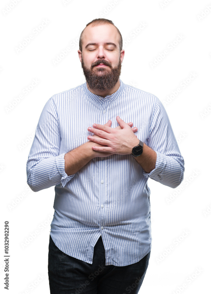 Young caucasian hipster man over isolated background smiling with hands on chest with closed eyes and grateful gesture on face. Health concept. Young caucasian hipster man over isolated background smiling with hands on chest with closed eyes and grateful gesture on face. Health concept.