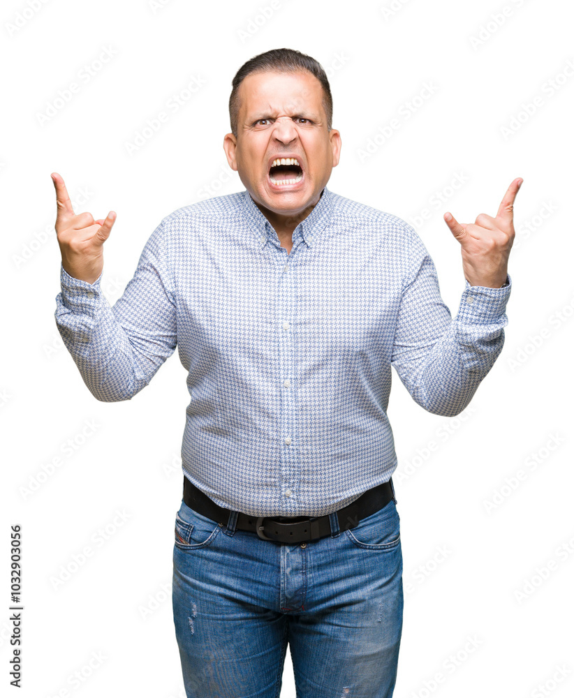 Naklejka premium Middle age arab business man over isolated background shouting with crazy expression doing rock symbol with hands up. Music star. Heavy concept.