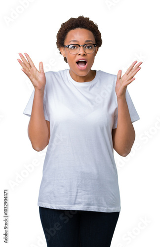 Beautiful young african american woman wearing glasses over isolated background celebrating crazy and amazed for success with arms raised and open eyes screaming excited. Winner concept