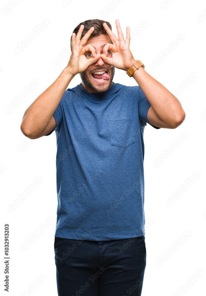 Young handsome man over isolated background doing ok gesture like binoculars sticking tongue out, eyes looking through fingers. Crazy expression. Young handsome man over isolated background doing ok gesture like binoculars sticking tongue out, eyes looking through fingers. Crazy expression.