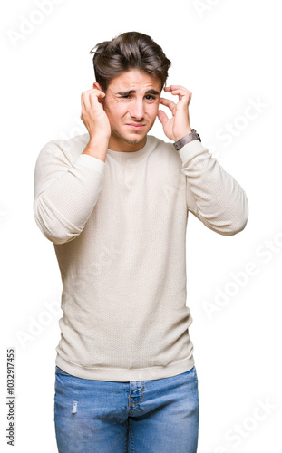 Young handsome man over isolated background covering ears with fingers with annoyed expression for the noise of loud music. Deaf concept.