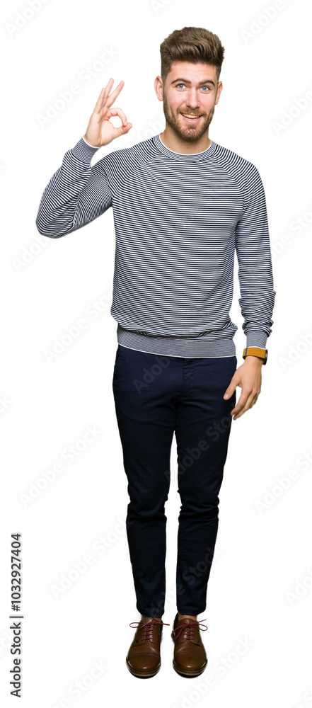 Young handsome man wearing stripes sweater smiling positive doing ok sign with hand and fingers. Successful expression. Young handsome man wearing stripes sweater smiling positive doing ok sign with hand and fingers. Successful expression.
