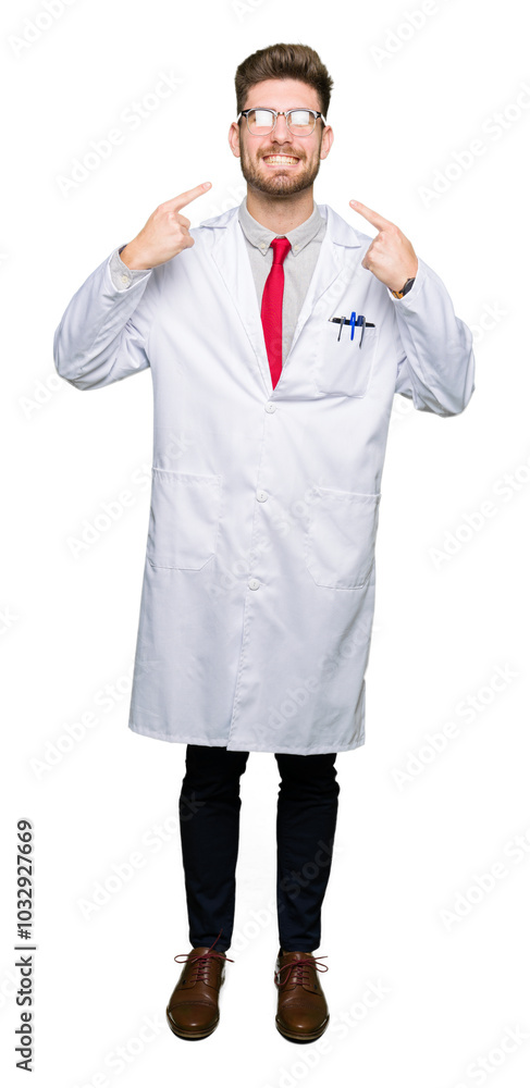 Young handsome scientist man wearing glasses smiling confident showing and pointing with fingers teeth and mouth. Health concept. Young handsome scientist man wearing glasses smiling confident showing and pointing with fingers teeth and mouth. Health concept.