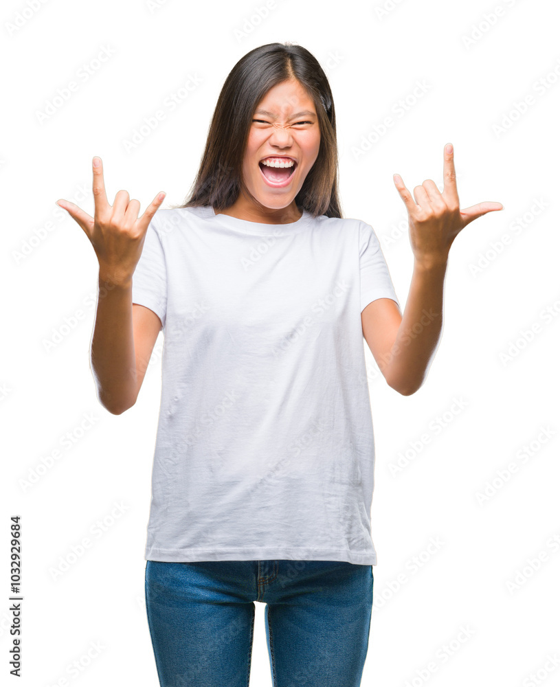 Young asian woman over isolated background shouting with crazy expression doing rock symbol with hands up. Music star. Heavy concept. Young asian woman over isolated background shouting with crazy expression doing rock symbol with hands up. Music star. Heavy concept.