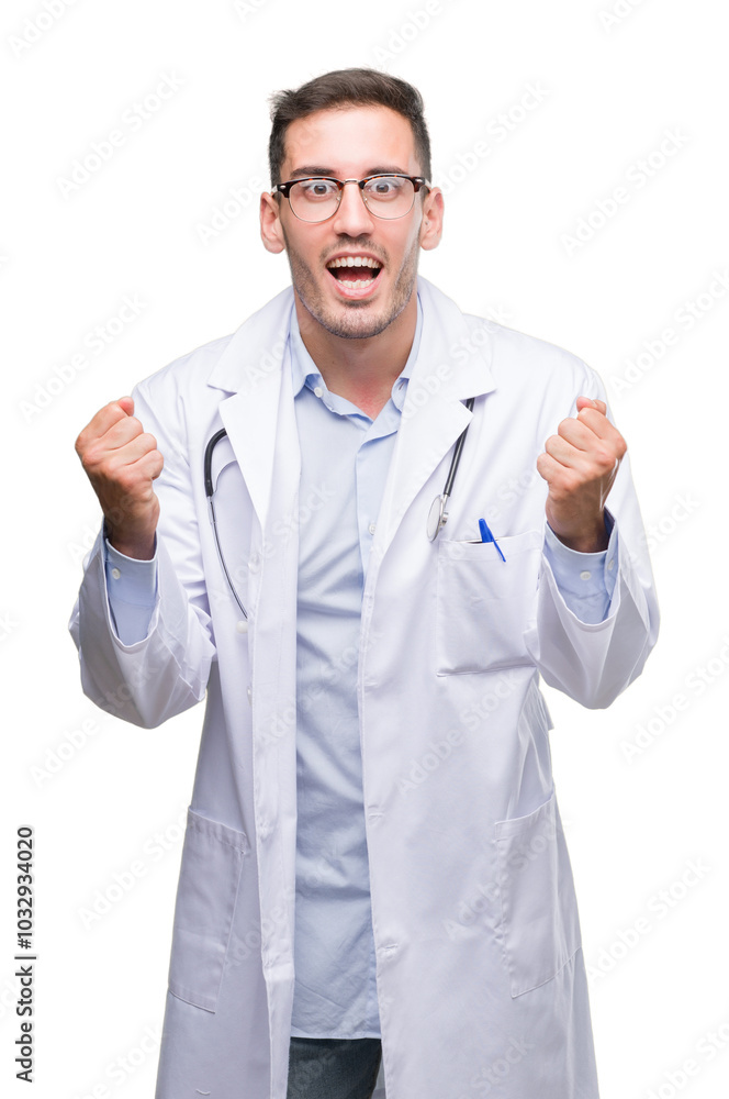 Handsome young doctor man celebrating surprised and amazed for success with arms raised and open eyes. Winner concept. Handsome young doctor man celebrating surprised and amazed for success with arms raised and open eyes. Winner concept.